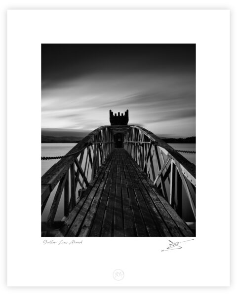 Bridge leading to the tower at Vartry Reservoir under dark clouds, County Wicklow, Ireland.