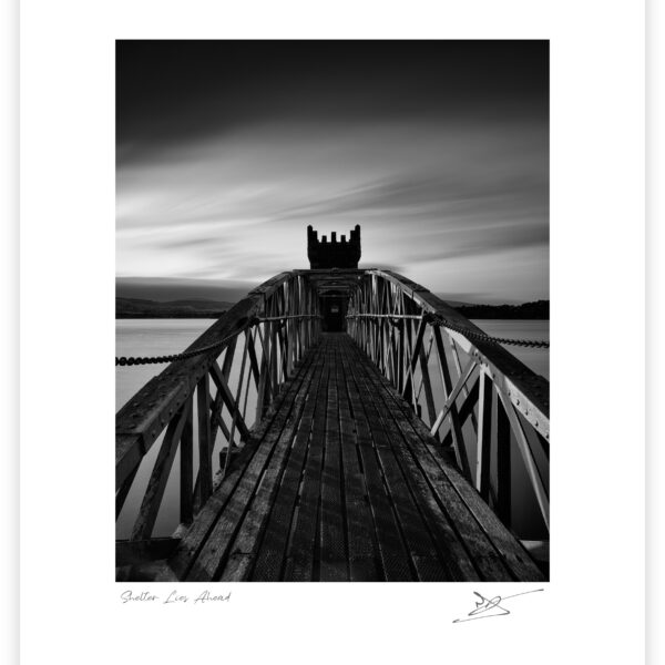Bridge leading to the tower at Vartry Reservoir under dark clouds, County Wicklow, Ireland.