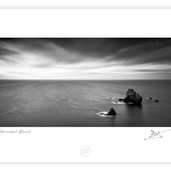 Sea stacks in shallow water at Caher Cove on the Copper Coast in County Waterford.