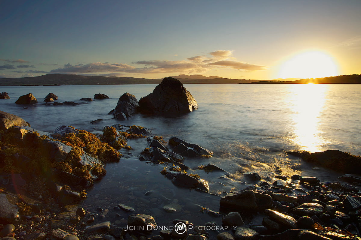 Golden Clouds above the mountains by John Dunne. 