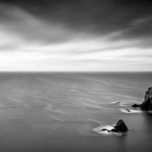 Sea stacks in shallow water at Caher Cove on the Copper Coast in County Waterford.