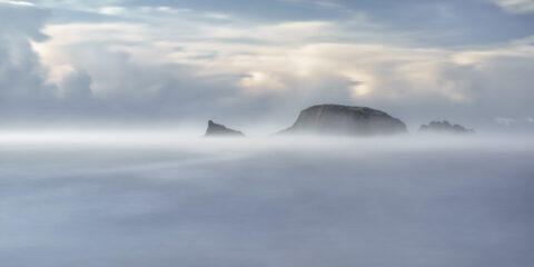 Sea mist partially obscuring Burke’s Island at Kilfarrasy Cove on the Copper Coast in County Waterford.