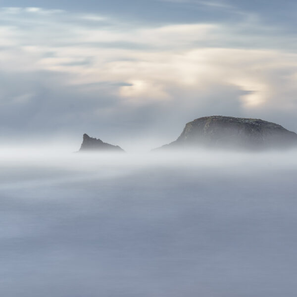 Sea mist partially obscuring Burke’s Island at Kilfarrasy Cove on the Copper Coast in County Waterford.
