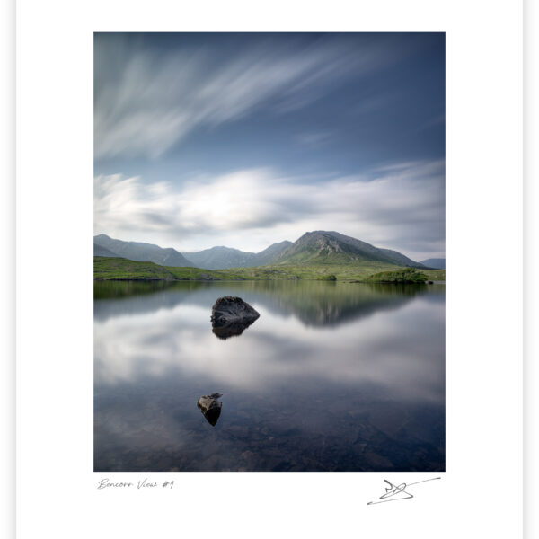 Mount Bencorr and the Twelve Pins reflected in calm water at Derryclare Lough in Connemara, Galway, Ireland, colour photograph.