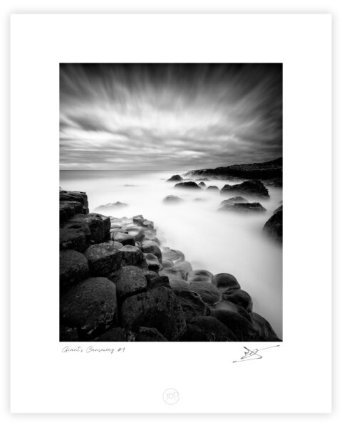 Basalt columns of the Giant’s Causeway with waves blurred by long exposure, County Antrim, Northern Ireland.