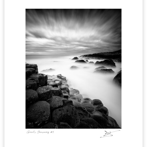 Basalt columns of the Giant’s Causeway with waves blurred by long exposure, County Antrim, Northern Ireland.