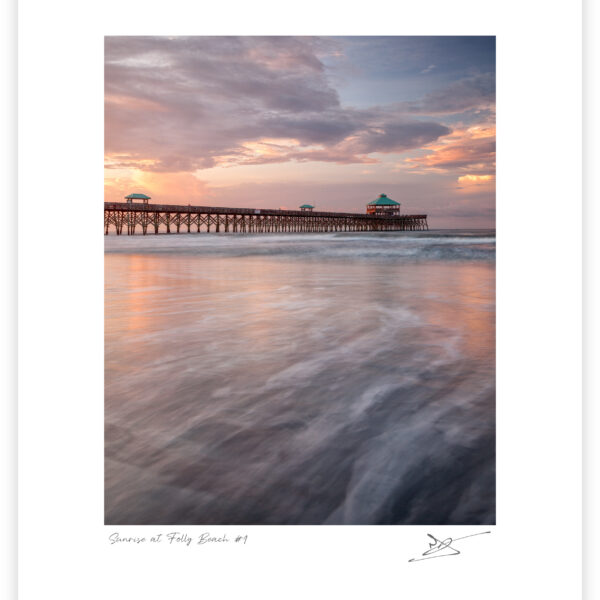 Folly Beach Fishing Pier at sunrise with soft waves and pastel sky in South Carolina, United States, colour photograph.