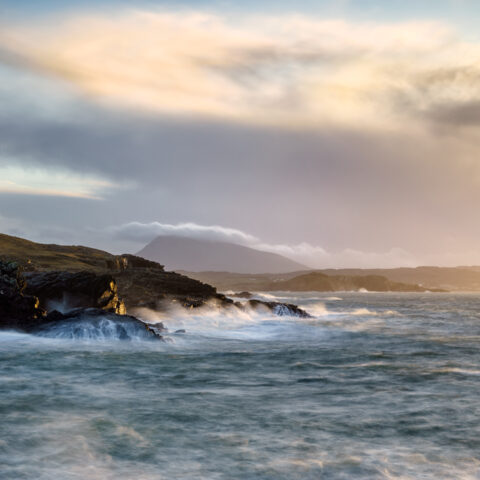 Stormy waves crashing against cliffs at Doagh on the Donegal coast under dramatic skies, Ireland, colour photograph.