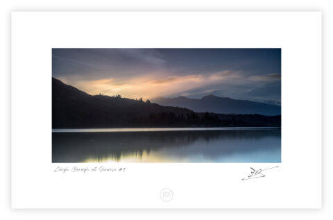 Dawn light over Lough Caragh reflecting clouds beneath Carrauntoohil in County Kerry, Ireland.