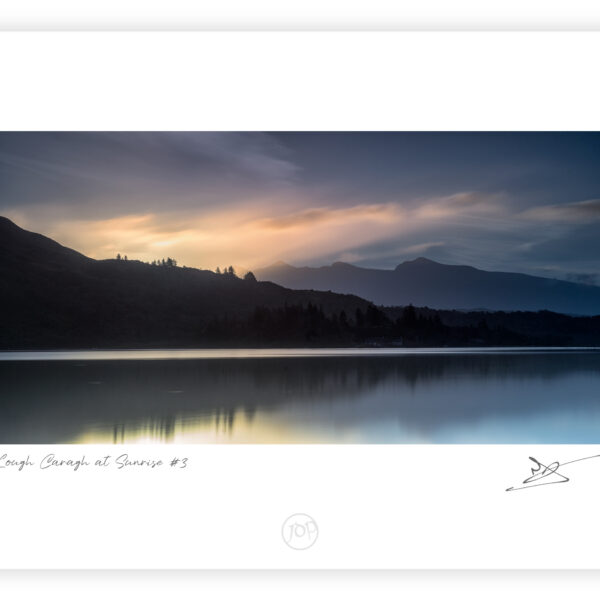 Dawn light over Lough Caragh reflecting clouds beneath Carrauntoohil in County Kerry, Ireland.
