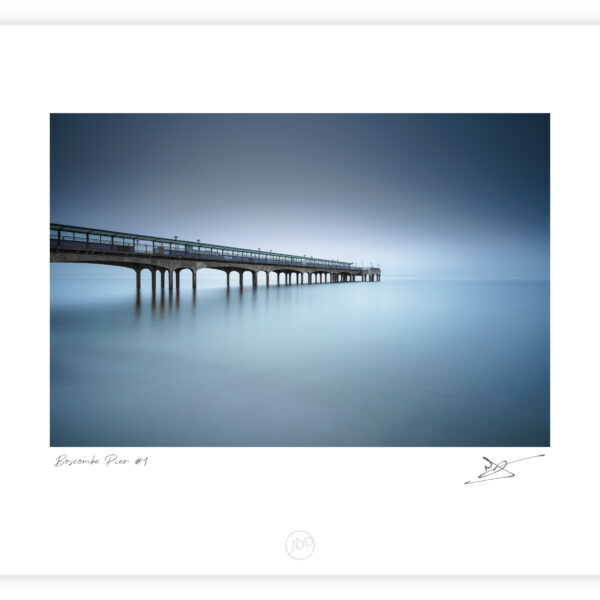 Boscombe Pier extending into a foggy sea at dawn in Bournemouth, England, colour photograph.