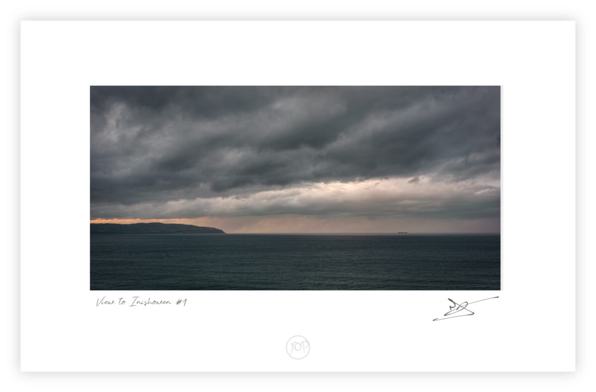 View toward the Inishowen Peninsula at sunset from near Mussenden Temple on the Derry coast, Northern Ireland, colour photograph.