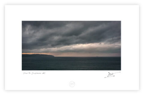 View toward the Inishowen Peninsula at sunset from near Mussenden Temple on the Derry coast, Northern Ireland, colour photograph.