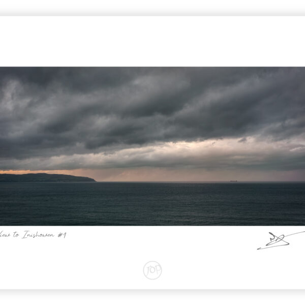 View toward the Inishowen Peninsula at sunset from near Mussenden Temple on the Derry coast, Northern Ireland, colour photograph.