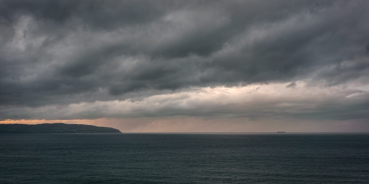 View to Inishowen #1 View toward the Inishowen Peninsula at sunset from near Mussenden Temple on the Derry coast, Northern Ireland, colour photograph.
