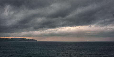 View toward the Inishowen Peninsula at sunset from near Mussenden Temple on the Derry coast, Northern Ireland, colour photograph.
