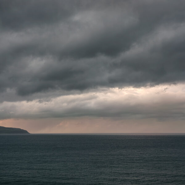 View toward the Inishowen Peninsula at sunset from near Mussenden Temple on the Derry coast, Northern Ireland, colour photograph.