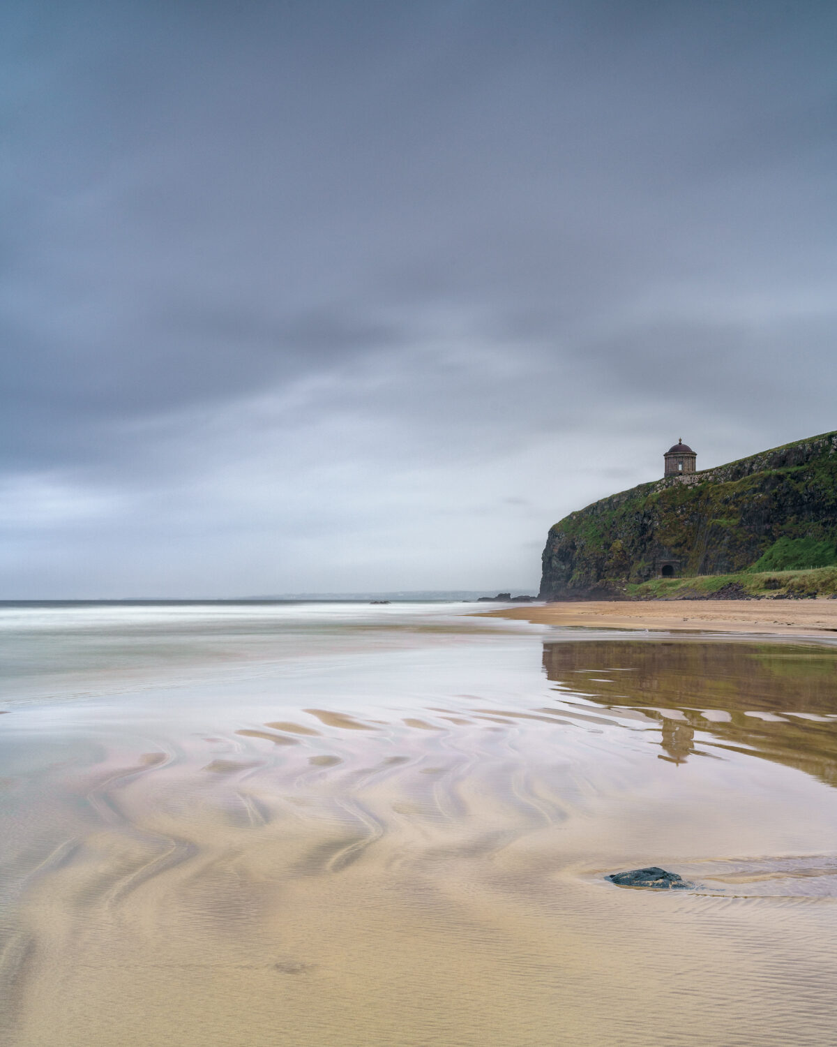 Mussenden Temple #1 Mussenden Temple on cliffs above Downhill Strand under an overcast sky in County Derry, Northern Ireland, colour photograph.