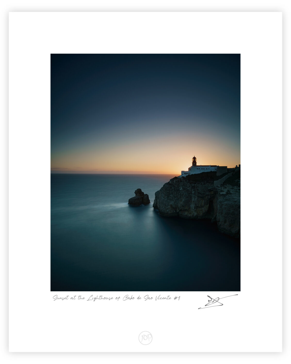 Lighthouse of Cabo de São Vicente on coastal cliffs at sunset in Sagres, Algarve, colour photograph.