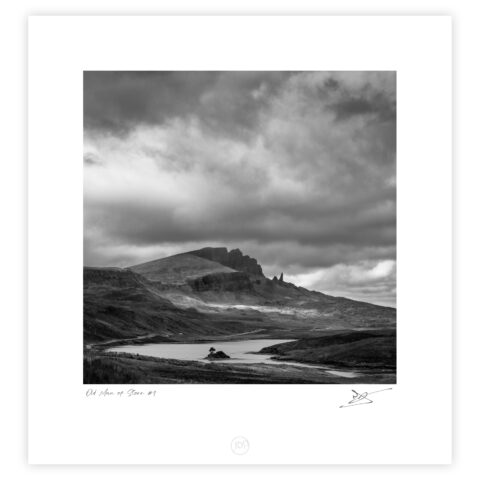 Old Man of Storr rock pinnacle beneath dark clouds on the Isle of Skye, Scotland, black and white photograph.