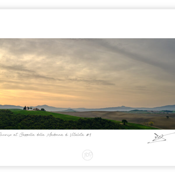 Cappella della Madonna di Vitaleta at sunrise with rolling Tuscan hills and soft clouds, Tuscany, Italy, colour photograph.