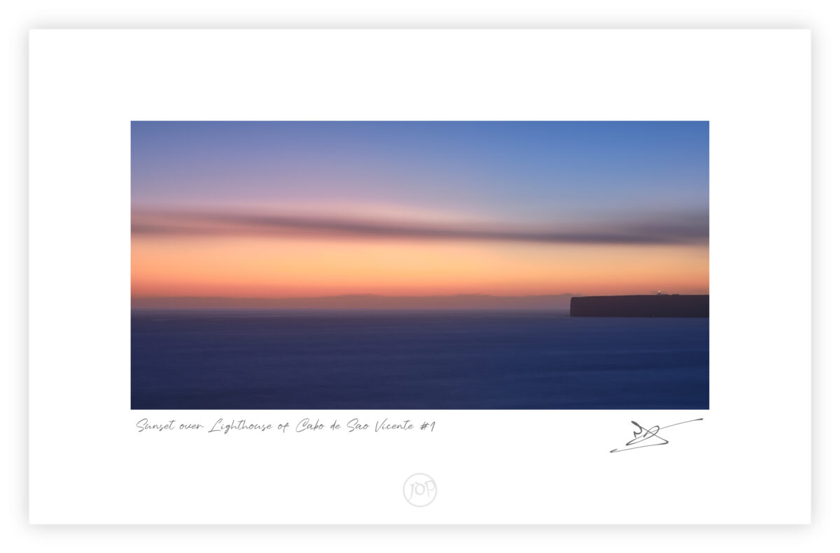 Sunset light behind Cabo de São Vicente Lighthouse in Sagres on the Algarve coast, colour photograph.