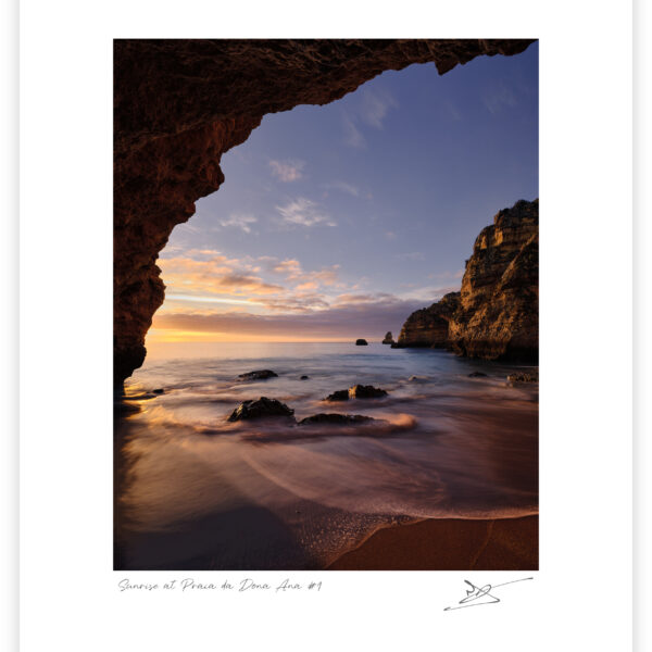 Sunrise light illuminating a sheltered cove at Praia da Dona Ana on the Algarve coast, colour photograph.