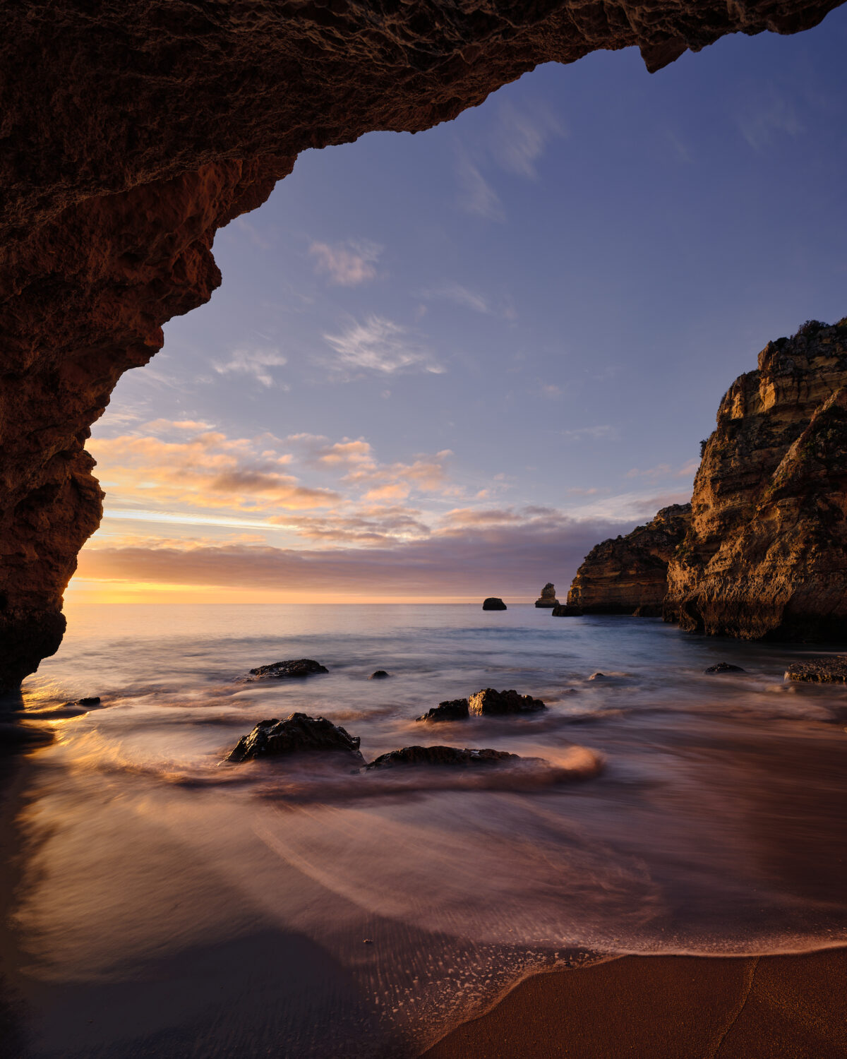 Sunrise at Praia da Dona Ana #1 - Warm, Glow, Secret Sunrise light illuminating a sheltered cove at Praia da Dona Ana on the Algarve coast, colour photograph.