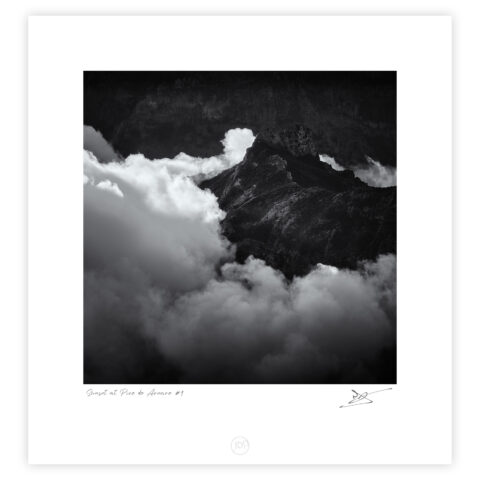 Pico do Areeiro mountain ridge emerging through cloud inversion at sunset, black and white photograph.