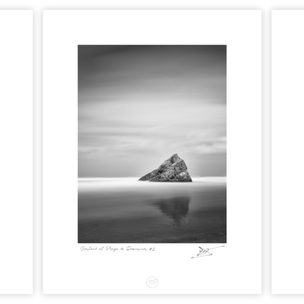 Black and white triptych of three sea stacks photographed with long exposure at Playa de Requesinos, Asturias, Spain, reflected in calm tidal water beneath a soft overcast sky.